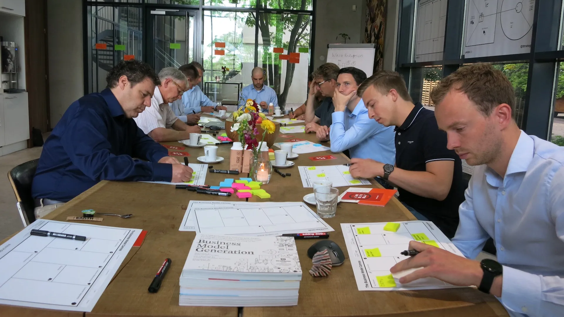 Participants working canvases on the wall during a session