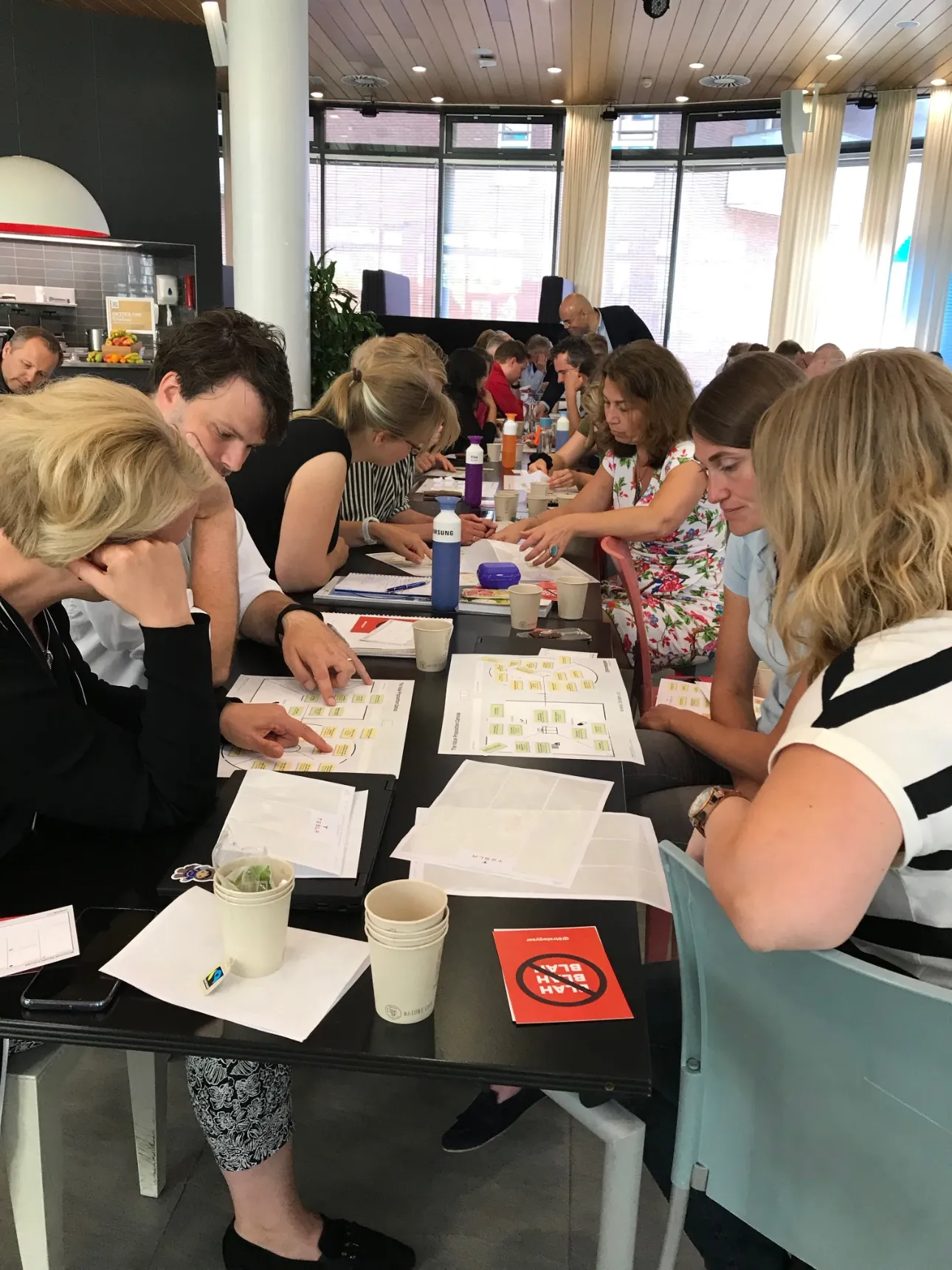 A training in progress: canvases on the wall, participants at work